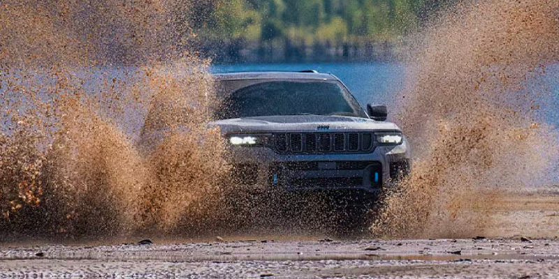 2025 Jeep Grand Cherokee driving through muddy terrain near Enumclaw, WA
