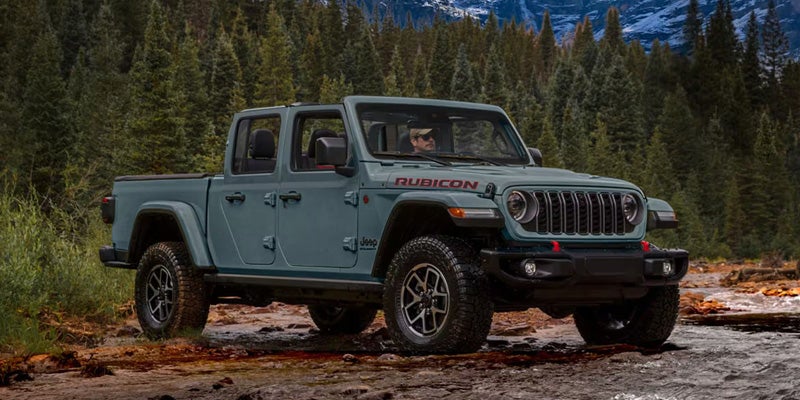 Off-road pickup truck navigating a rugged forest trail.