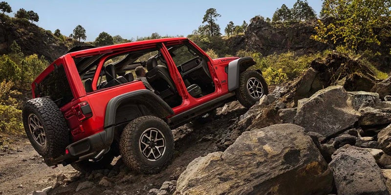 red 2026 jeep wrangler off-roading mountain
